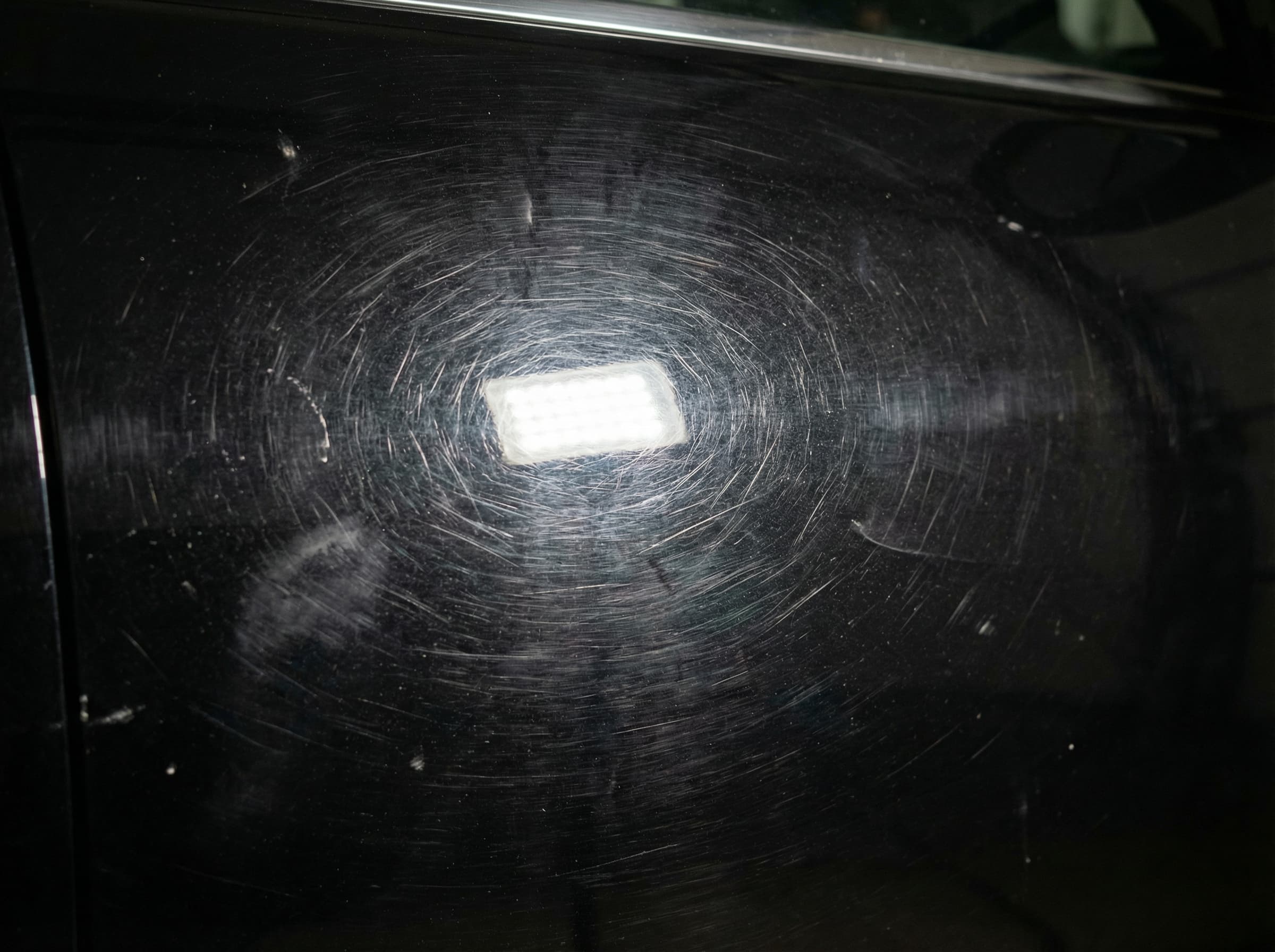 Car paint with swirl marks before correction