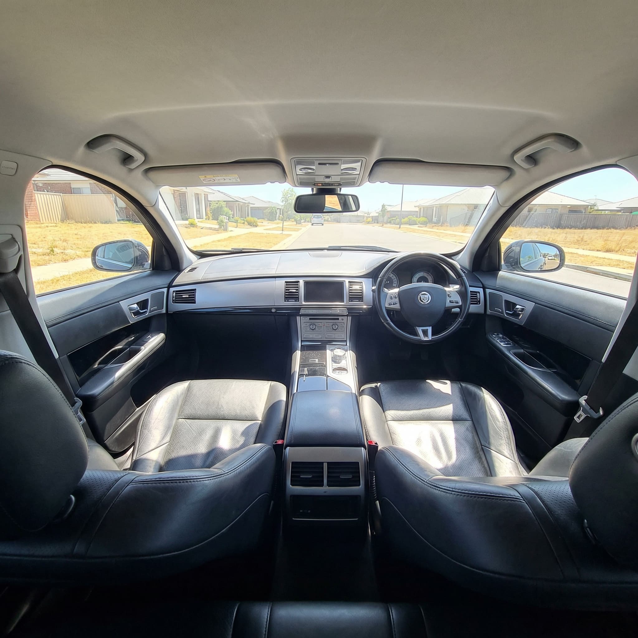 Car interior before window tinting showing sun glare