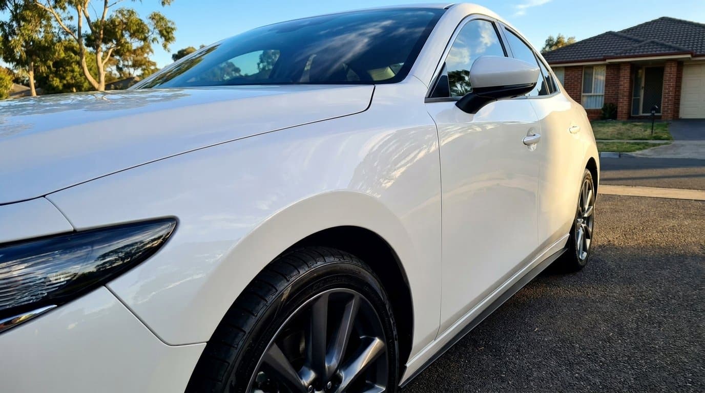 New white car in Australian driveway in afternoon light